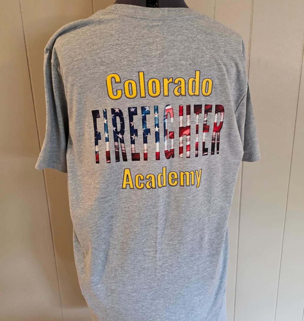 Completed Colorado Firefighter Academy shirt featuring a large American-flag firefighter back design